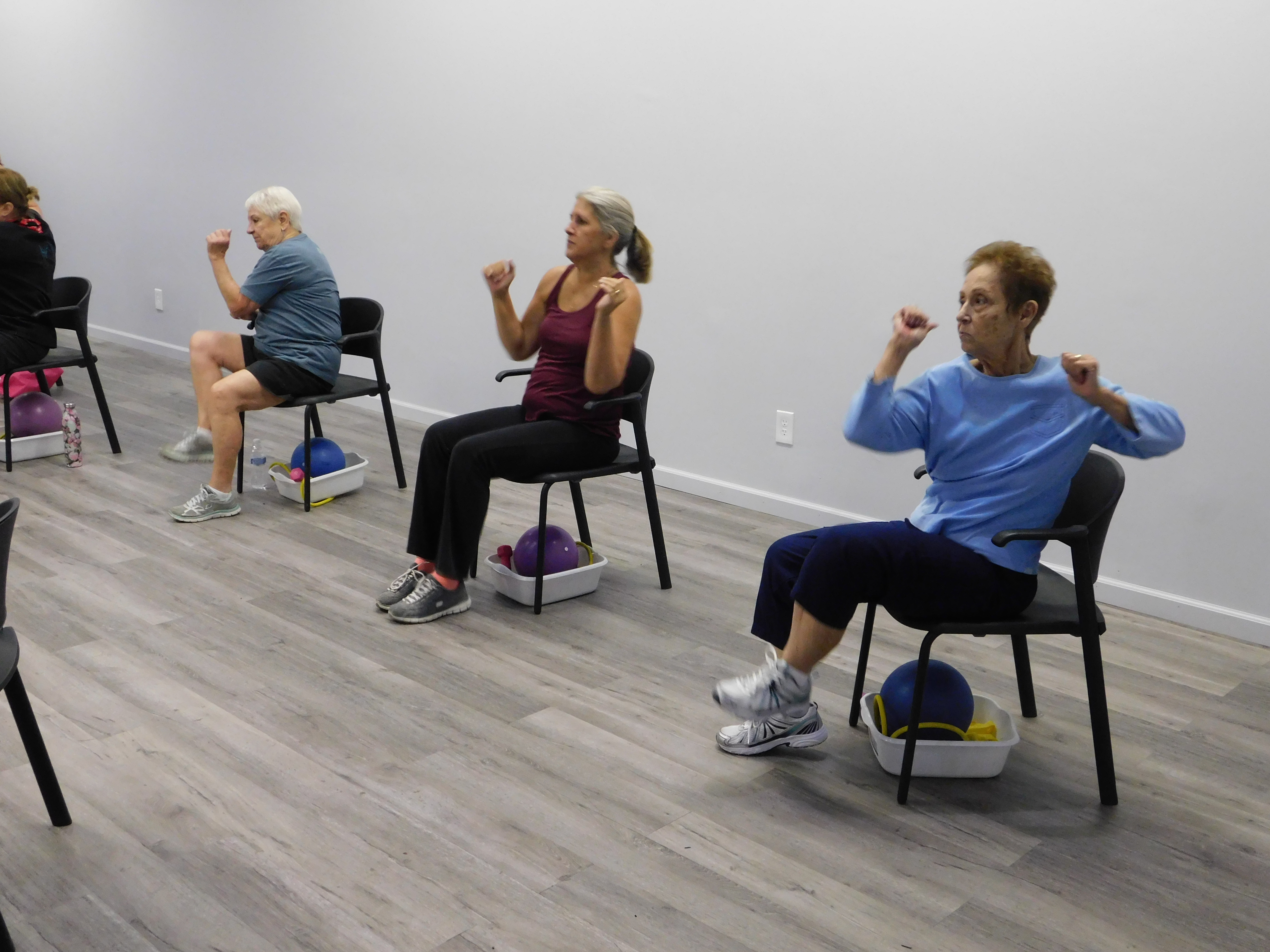 Women Doing Exercises in Chairs